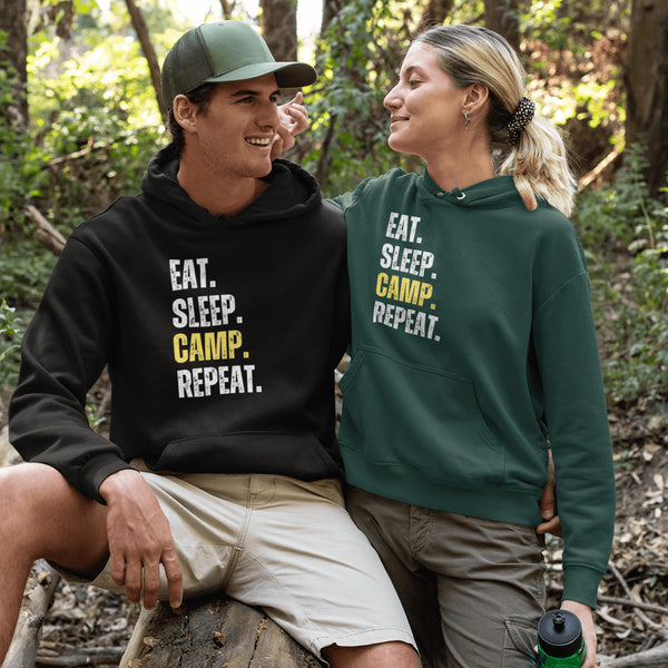 Introducing the ultimate camper's companion: the "Eat. Sleep. Camp. Repeat." Hoodie! This isn't just any ordinary piece of clothing. It's your best friend in the wilderness, your cozy confidante under the stars, and quite possibly the most honest representation of your weekend plans.
